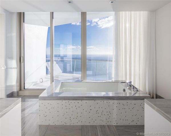 a bathroom with bathtub and window