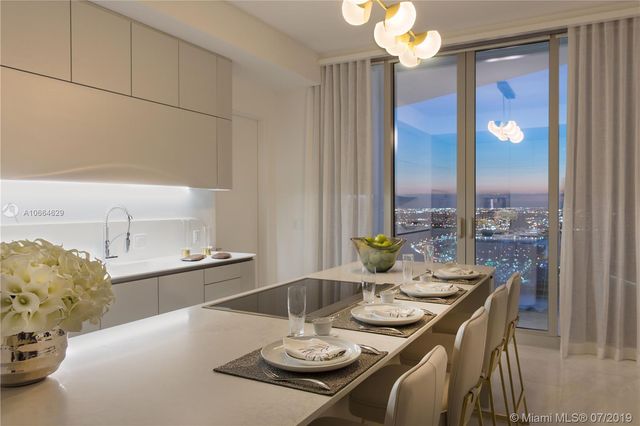 a dining room with furniture and a chandelier