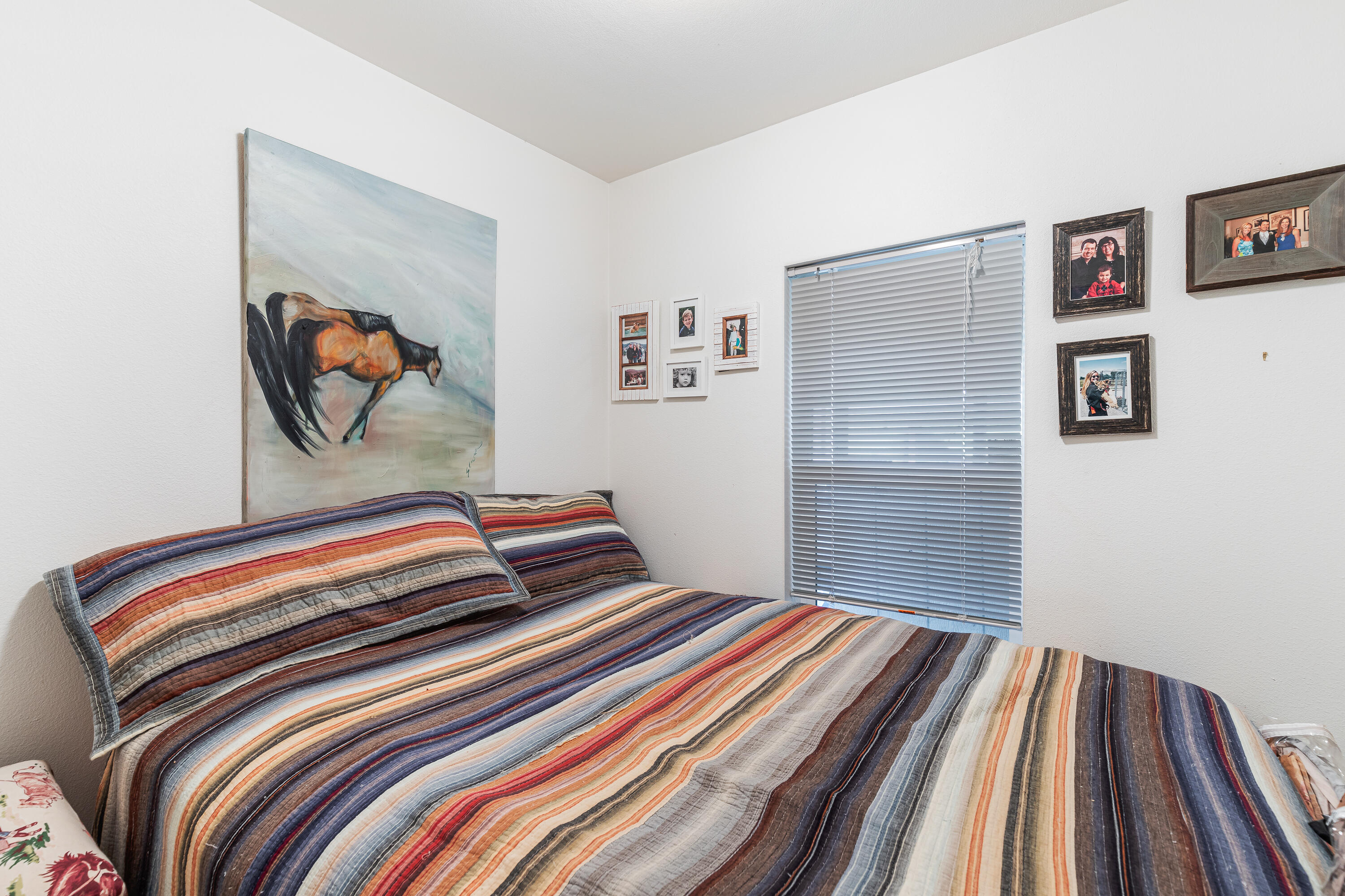 13721 Upper Applegate Road Jacksonville, OR 97530 - Photo 14 of 26 a bedroom with a bed and a painting on the wall