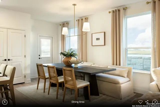 a view of a dining room with furniture and a potted plant