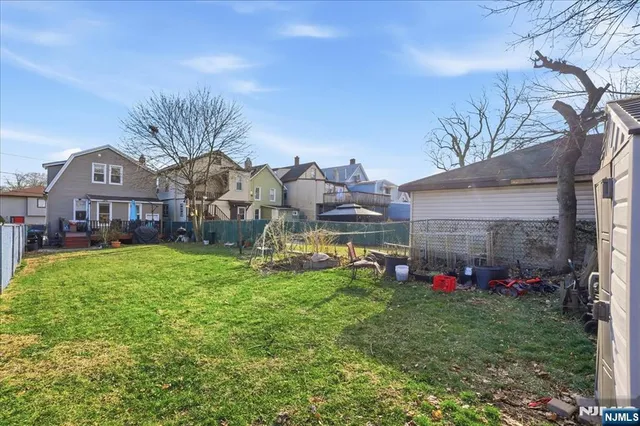 a view of a house with a big yard and potted plants