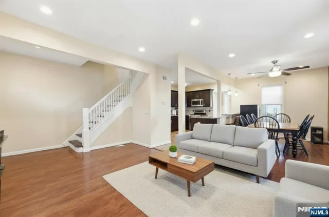 a living room with furniture and wooden floor