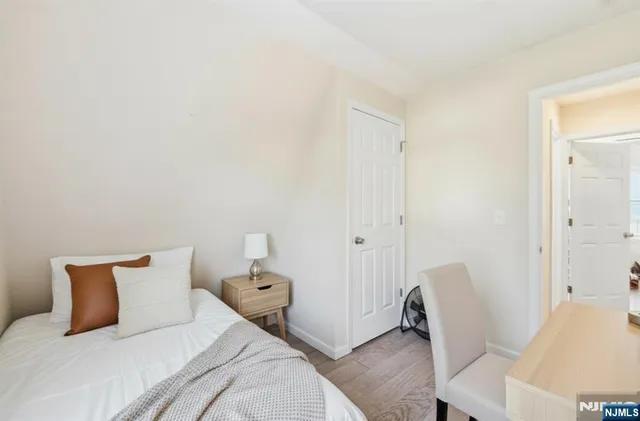 a bedroom with a bed and chair