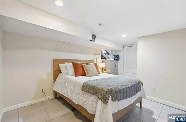 a bedroom with a bed and a night stand