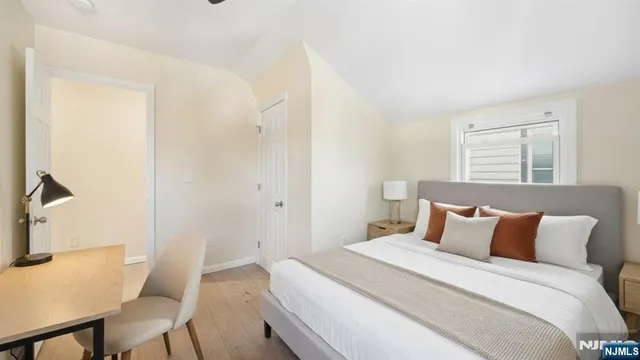 a bedroom with a bed and a table in it