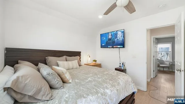 a bedroom with bed and a view of room