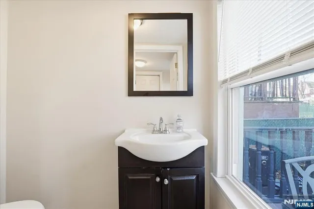 a bathroom with a sink a mirror and a toilet