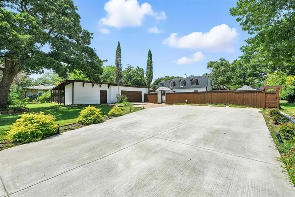 an aerial view of a house with a yard and potted plants