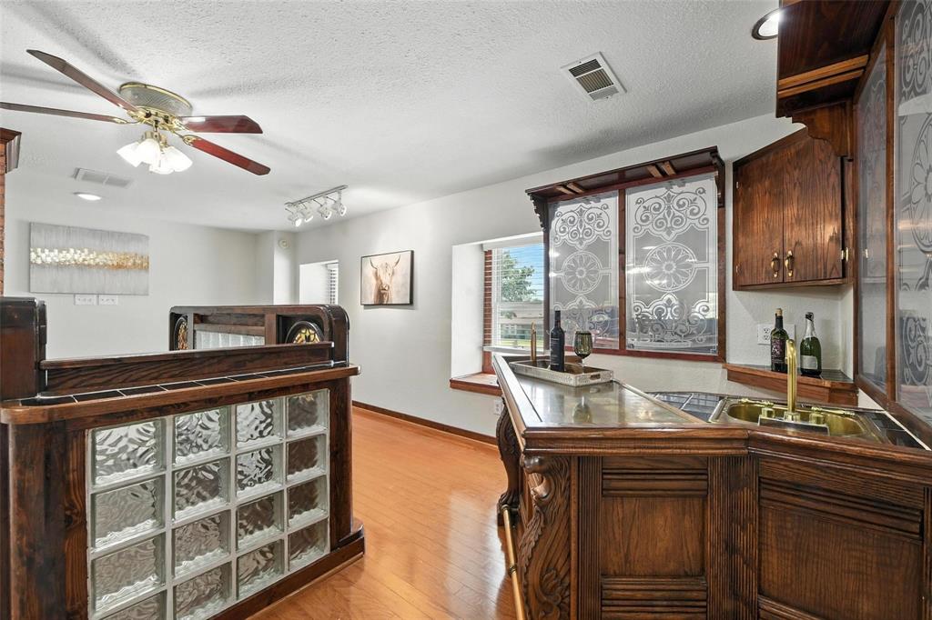 1323 Dublin Street Grapevine, TX 76051 - Photo 5 of 16 a kitchen with a stove a sink and cabinets