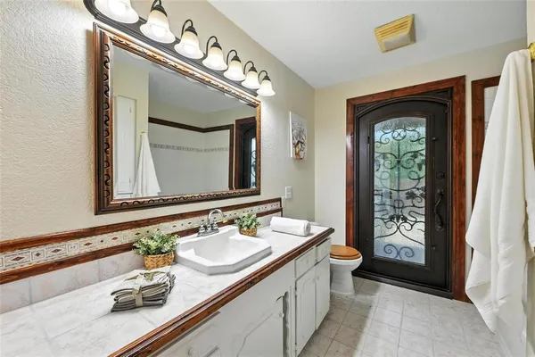 a bathroom with a sink vanity and a mirror