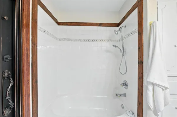 a bathroom with a shower and a glass door