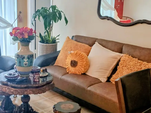a living room with furniture and flowers