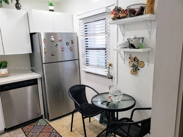 a kitchen with a refrigerator and a table