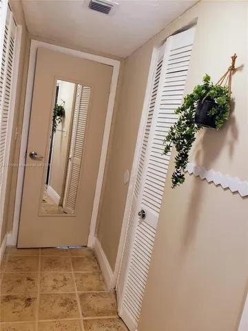 an entryway with a flower pot