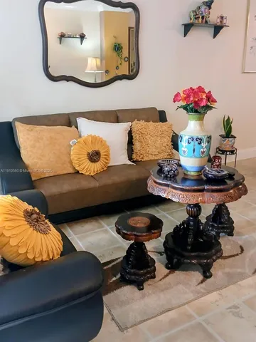 a living room with furniture and flowers