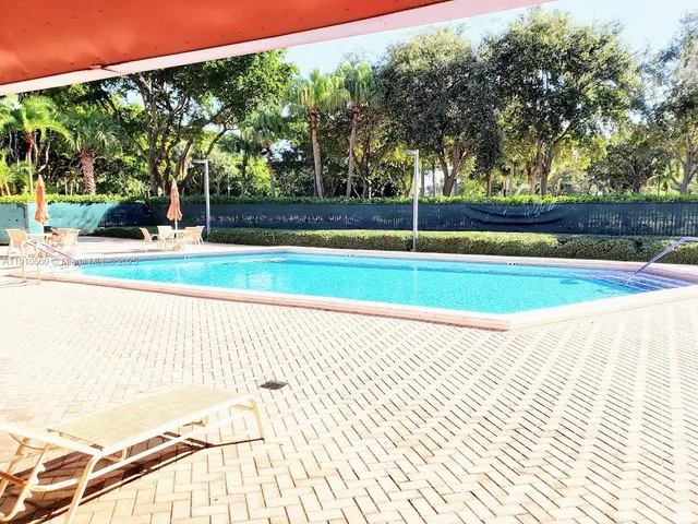 a view of swimming pool with seating space