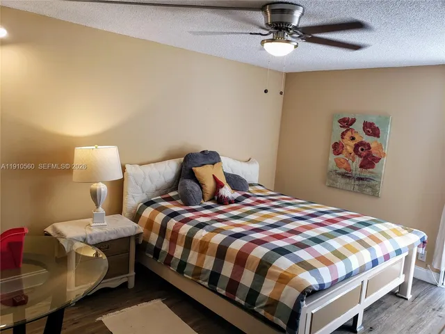 a bedroom with a bed and painting on the wall