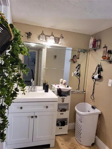 a bathroom with a sink toilet and mirror