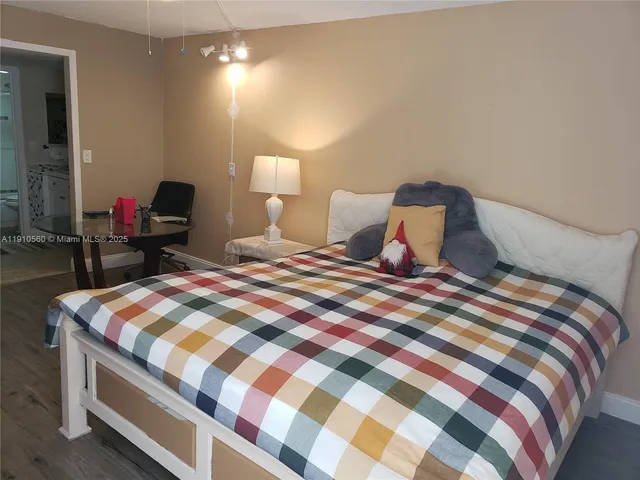 a bedroom with a bed and lamp