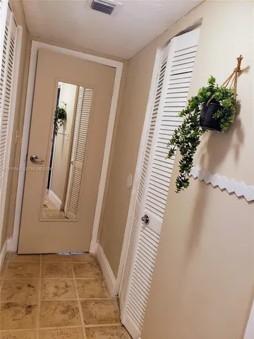 an entryway with a flower pot