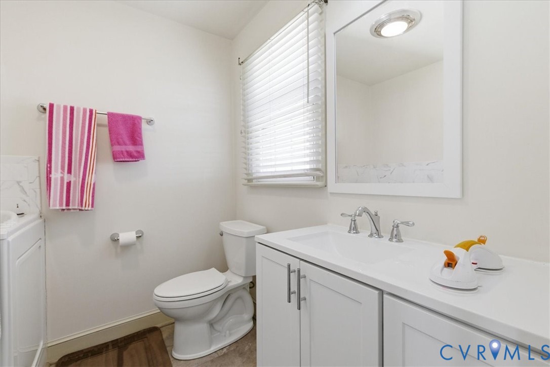37023 Old Wakefield Road Wakefield, VA 23888 - Photo 34 of 51 a bathroom with a sink toilet and a window