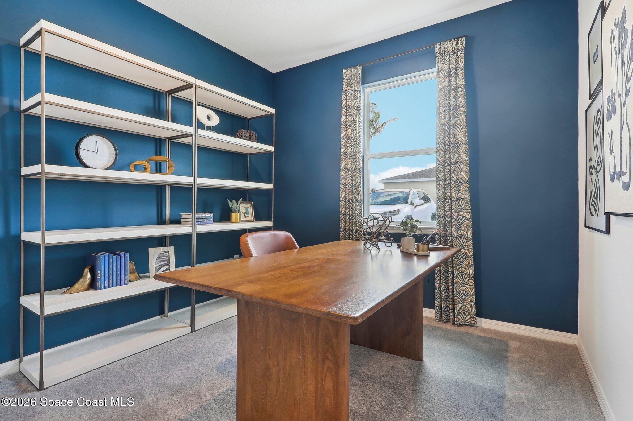 1332 Dunblane Way Northeast Palm Bay, FL 32905 - Photo 25 of 32 a room with a workspace and a bookshelf