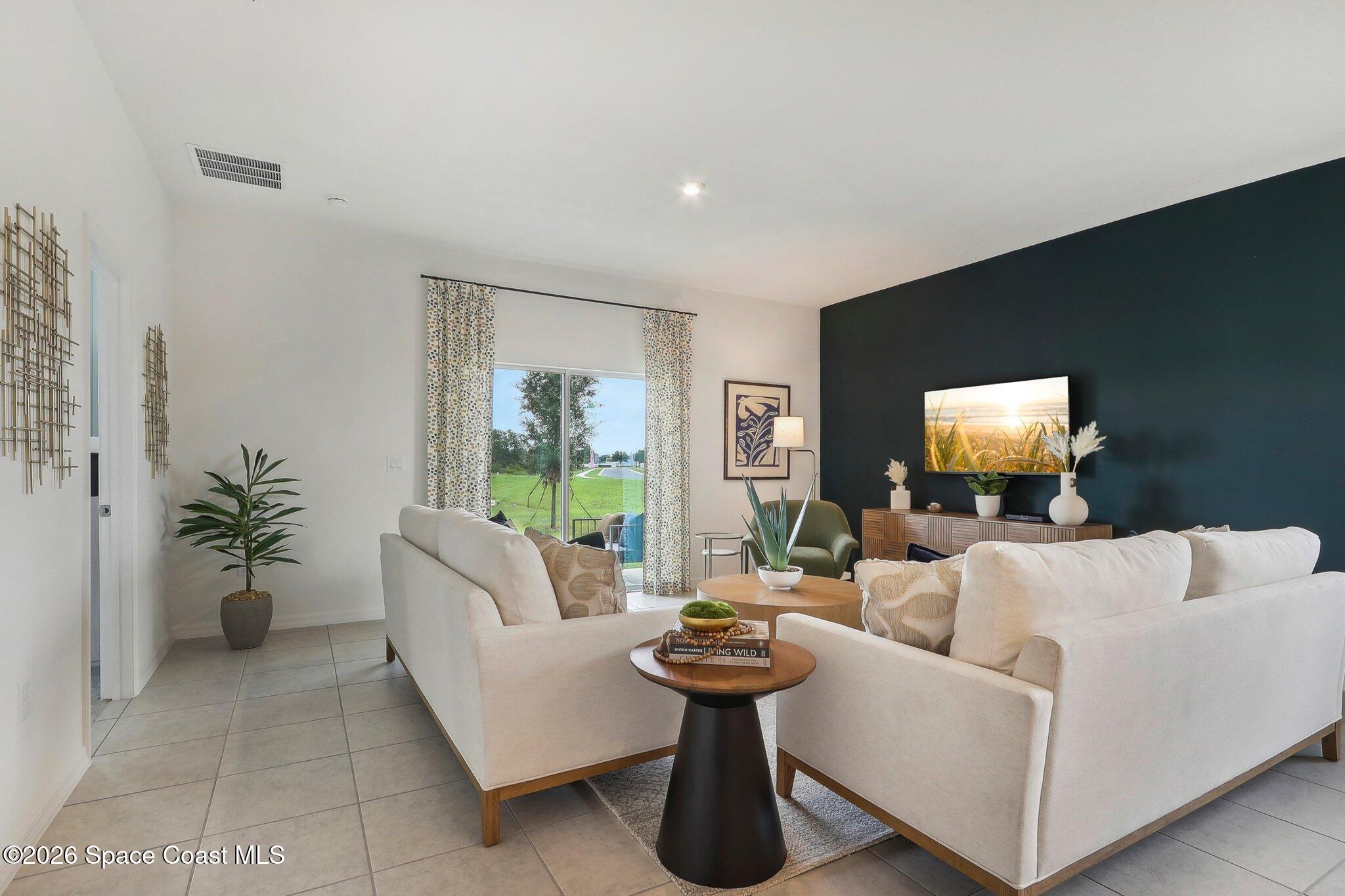 1332 Dunblane Way Northeast Palm Bay, FL 32905 - Photo 4 of 32 a living room with furniture and a flat screen tv