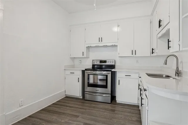 a kitchen with a sink cabinets and stainless steel appliances