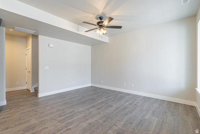 2249 South 1090 West, Unit 76 Nibley, UT 84321 - Photo 5 of 19 Spacious room featuring wood-finish flooring, light-toned walls, and a ceiling fan with integrated lighting