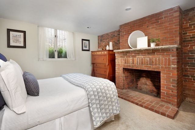 a bedroom with a bed and a fireplace