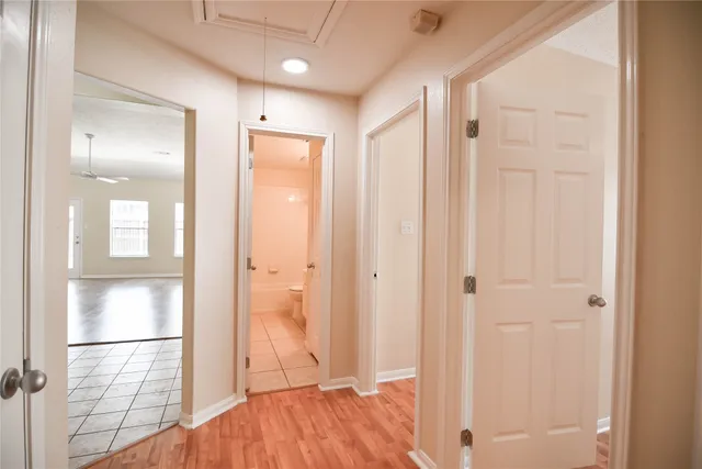 a view of a hallway with wooden floor and closet area