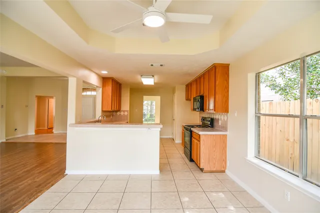a kitchen with stainless steel appliances granite countertop a refrigerator and a stove top oven