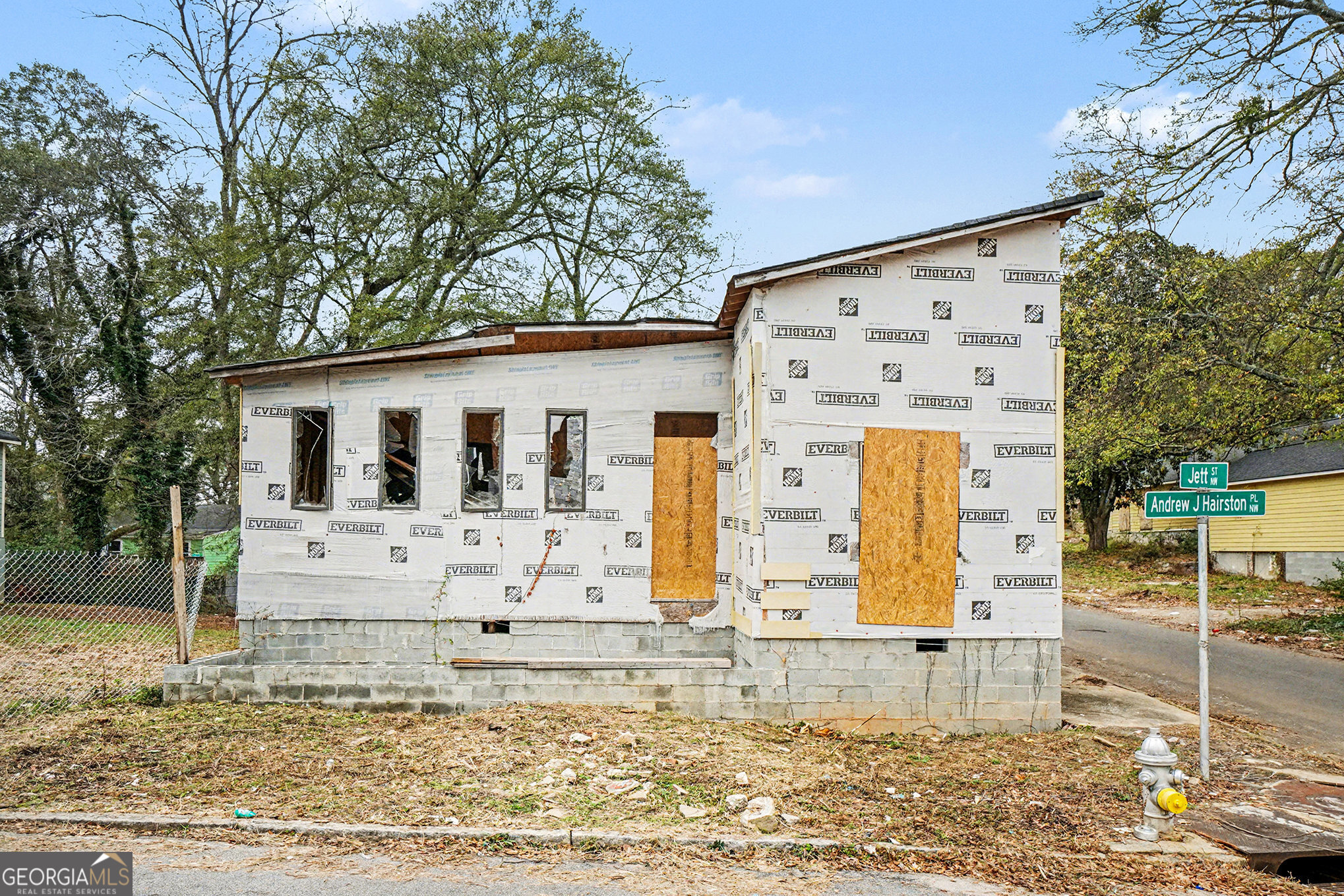 a view of a white house with large windows