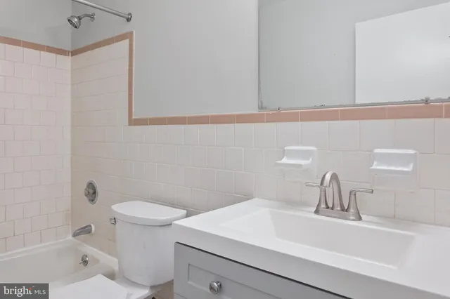 a bathroom with a toilet and a bathtub