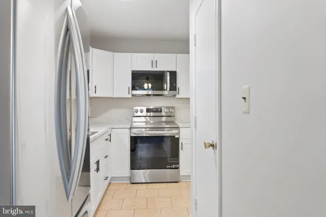 a kitchen with stainless steel appliances a stove a sink and a microwave