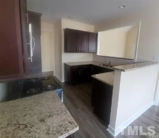 a kitchen with a stove and a refrigerator