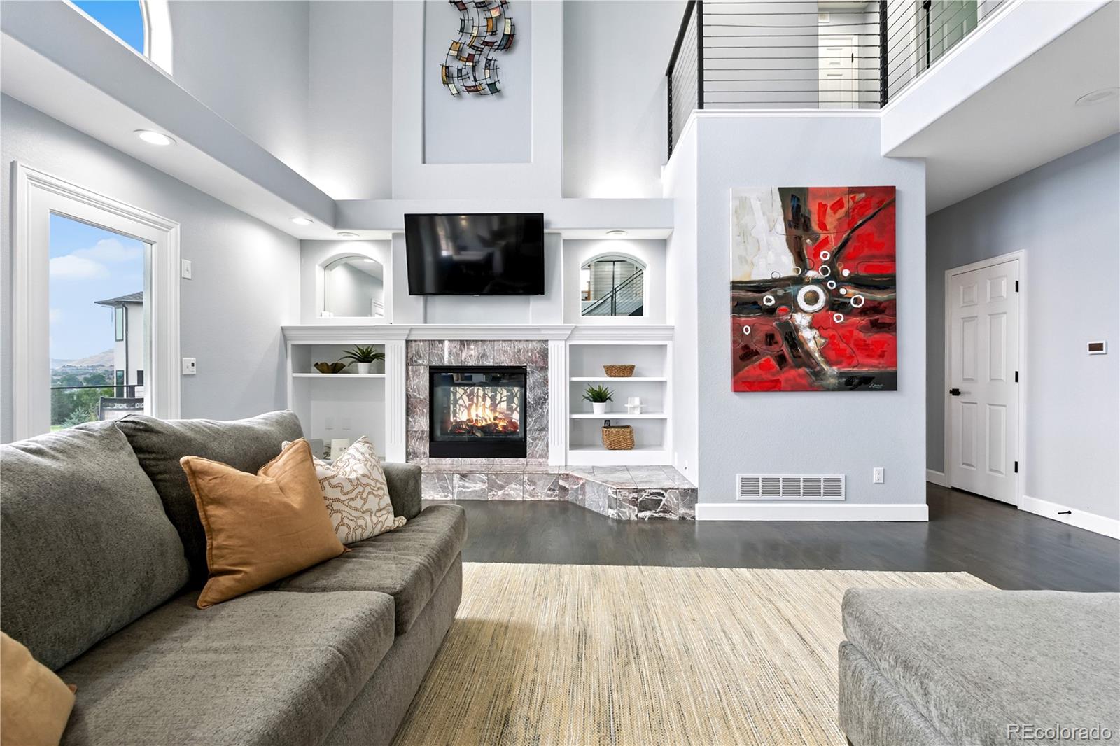 7092 Secrest Court Arvada, CO 80007 - Photo 12 of 49 a living room with furniture fireplace and flat screen tv