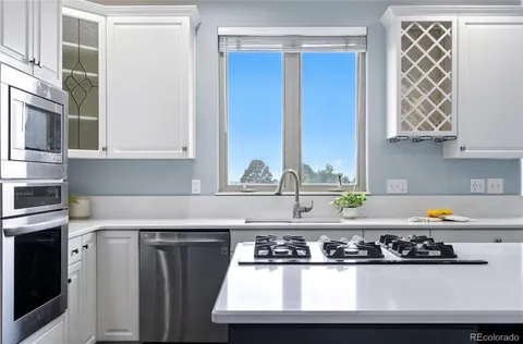 a kitchen with a sink a stove and cabinets