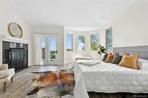 a bedroom with a bed a mirror and a large window