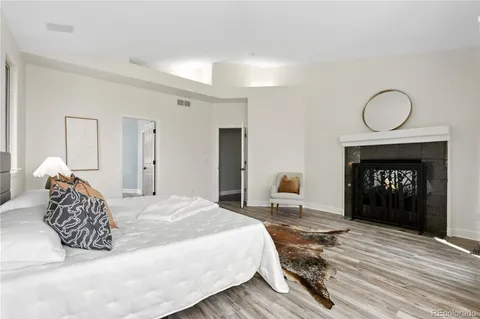 a bedroom with a bed and a fireplace