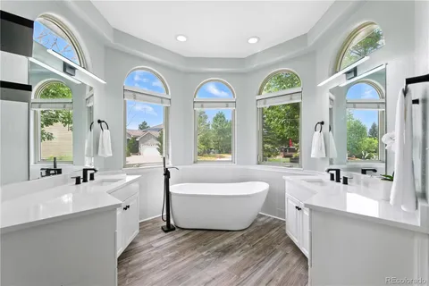 a bathroom with a large tub and 2 sink