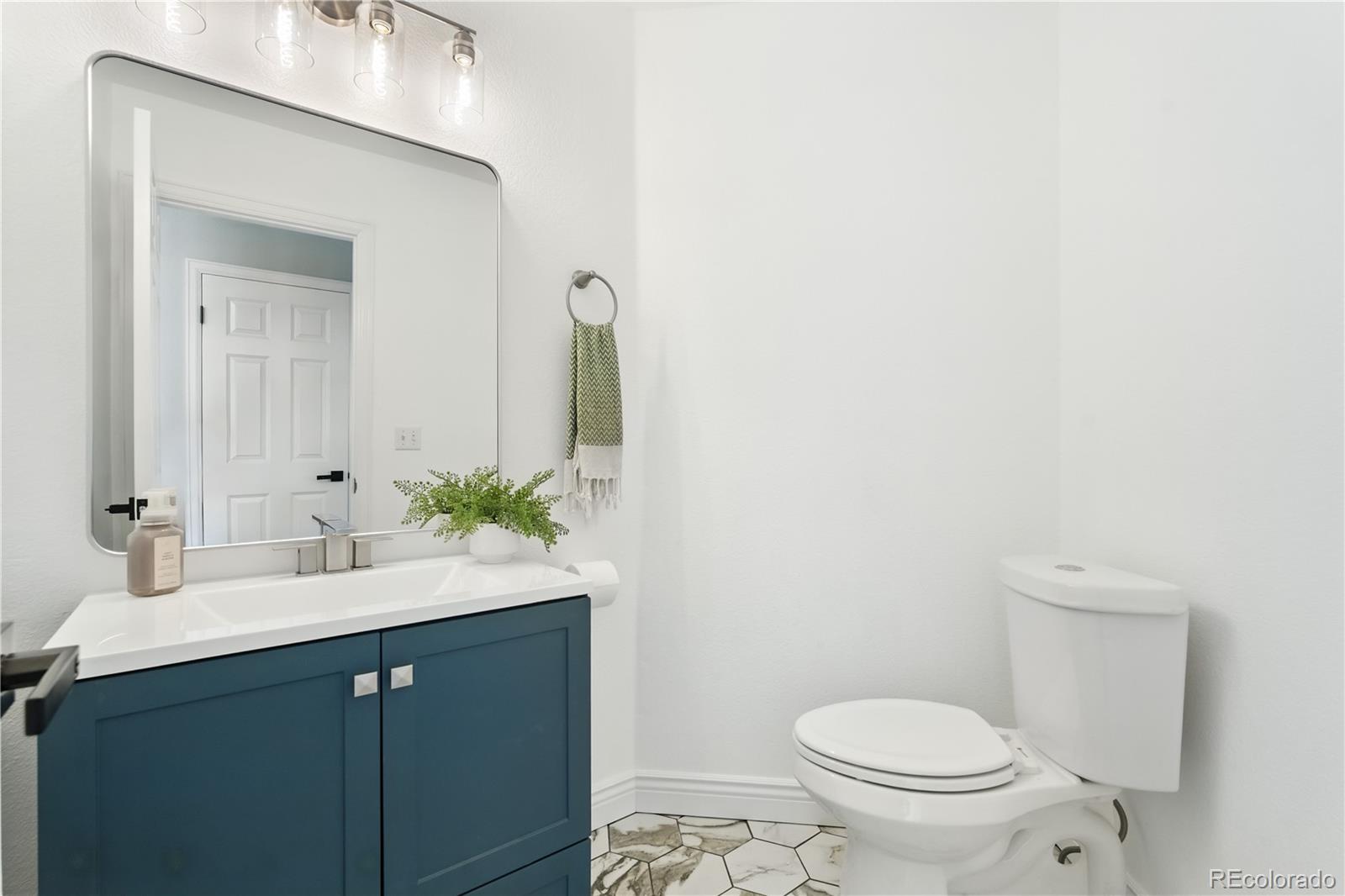 7092 Secrest Court Arvada, CO 80007 - Photo 25 of 49 a bathroom with a sink and a toilet