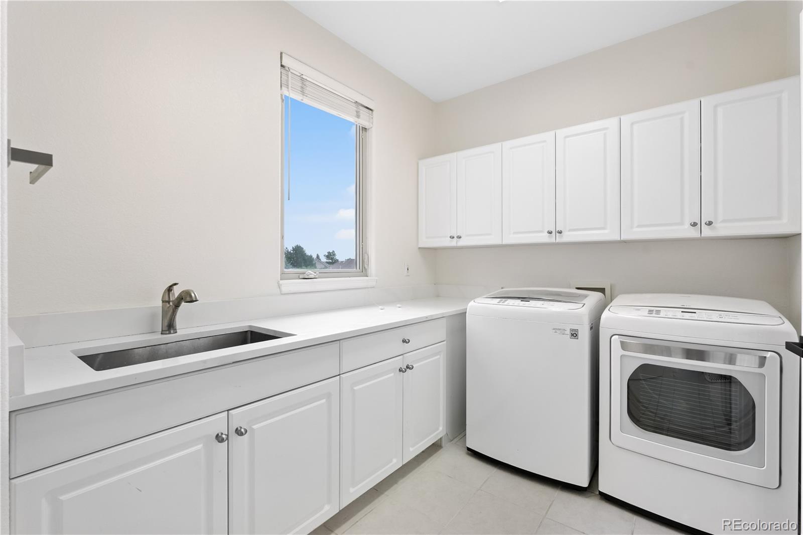 7092 Secrest Court Arvada, CO 80007 - Photo 26 of 49 a utility room with sink dryer and washer