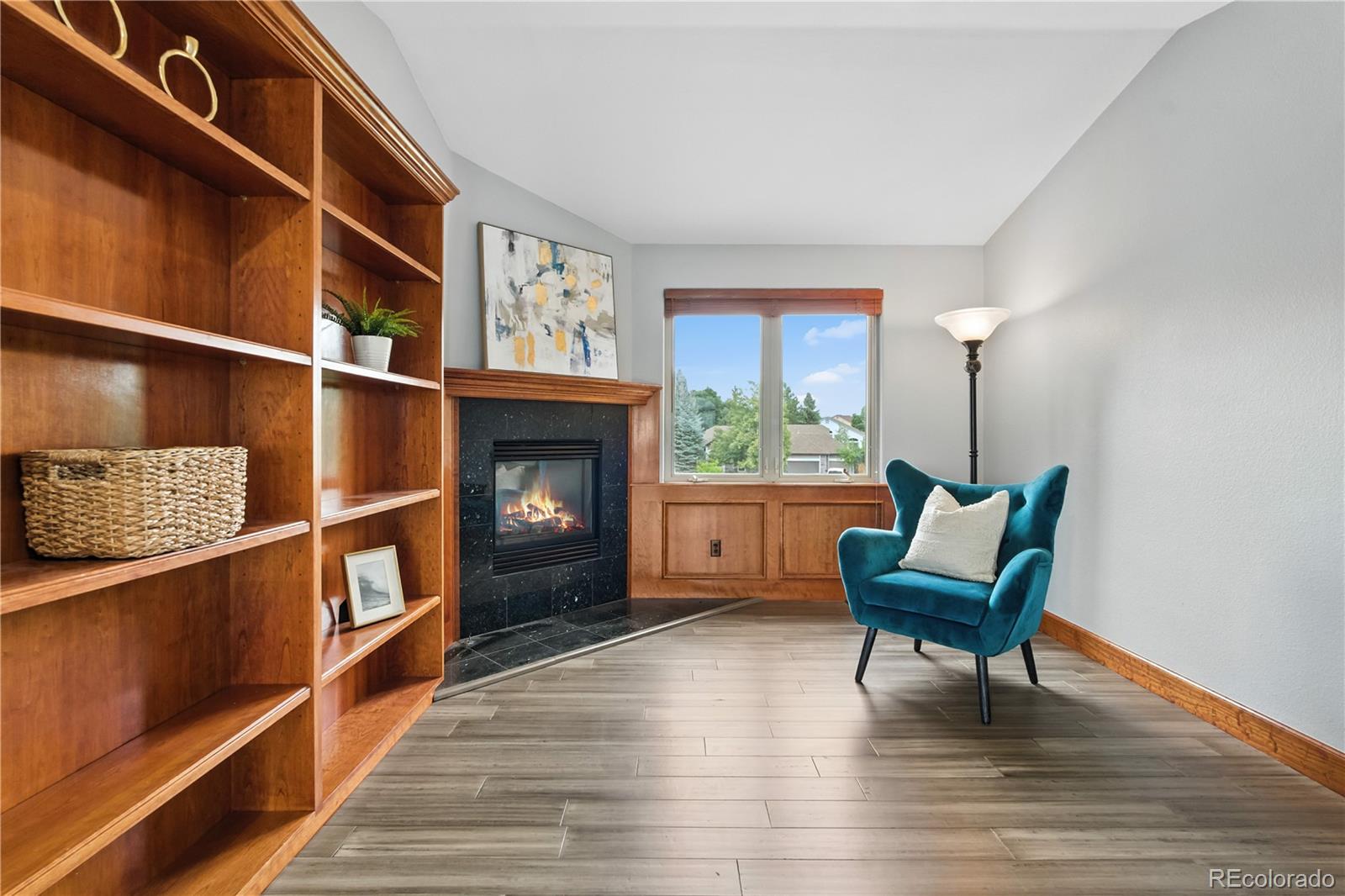 7092 Secrest Court Arvada, CO 80007 - Photo 29 of 49 a living room with furniture wooden floor and a fireplace