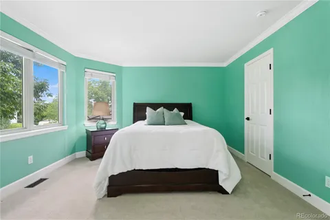 a bed sitting in a bedroom next to a window