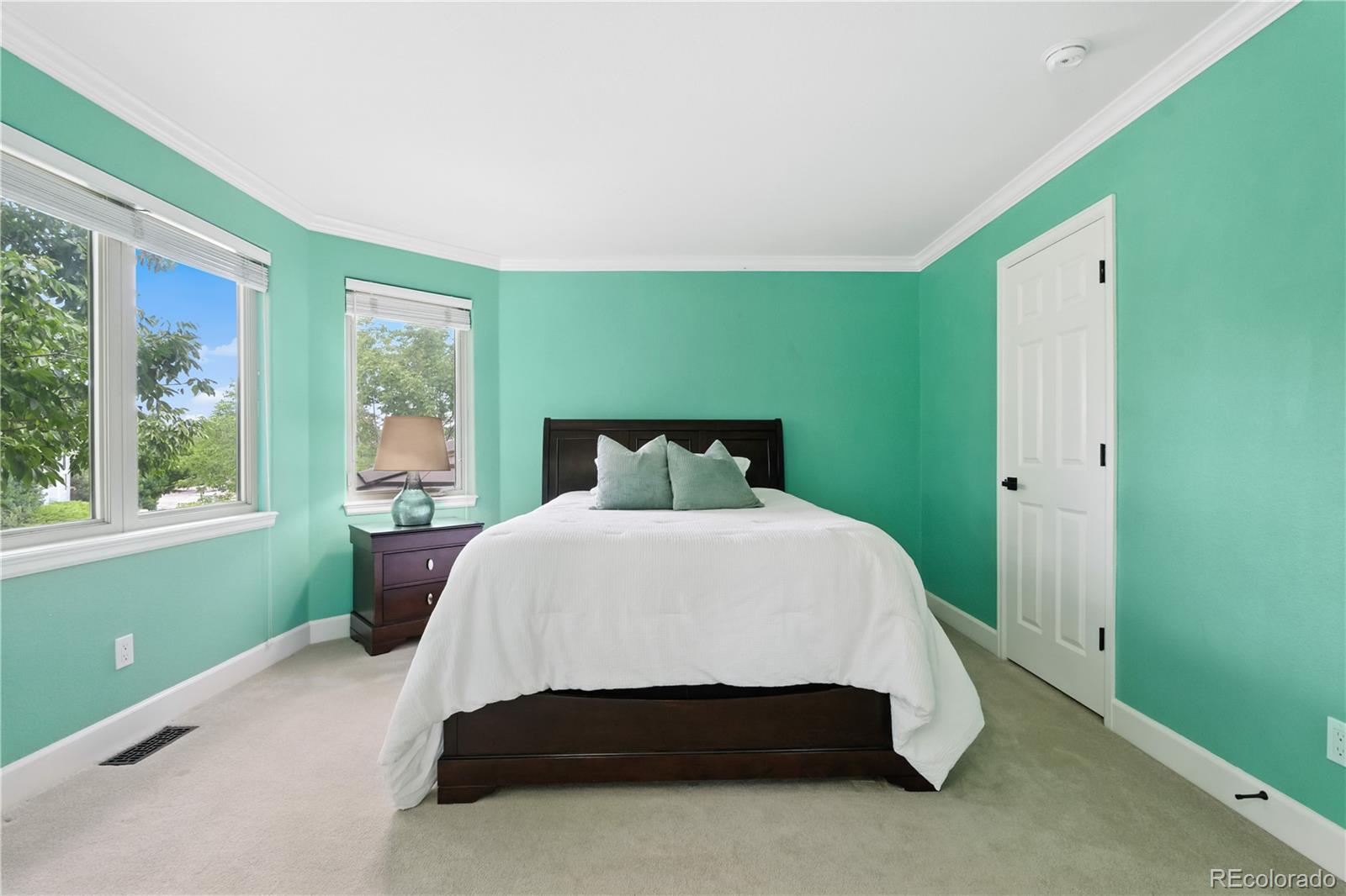 7092 Secrest Court Arvada, CO 80007 - Photo 30 of 49 a bed sitting in a bedroom next to a window