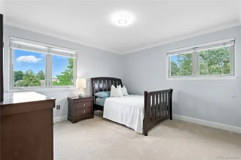 a bedroom with a bed lamp and window