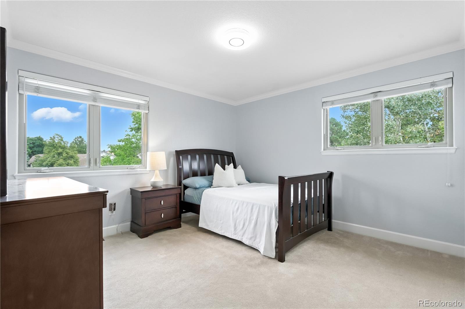 7092 Secrest Court Arvada, CO 80007 - Photo 31 of 49 a bedroom with a bed lamp and window