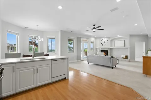 a large white kitchen with stainless steel appliances kitchen island a white counter space a sink and a window