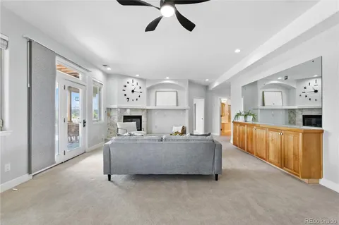 a living room with furniture and a kitchen
